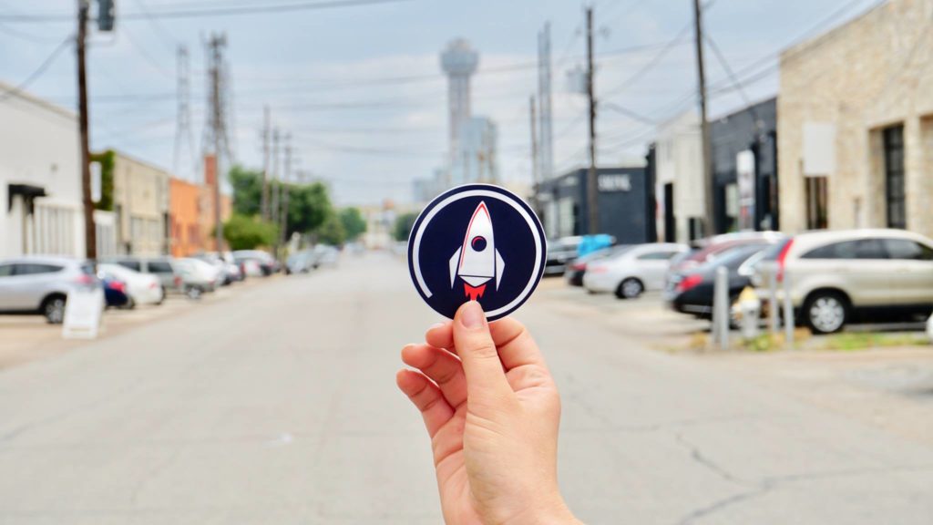 RocketBrand Sticker with Dallas in the background